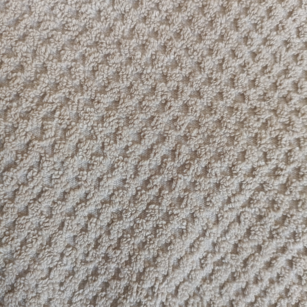 Close-up of textured beige carpet