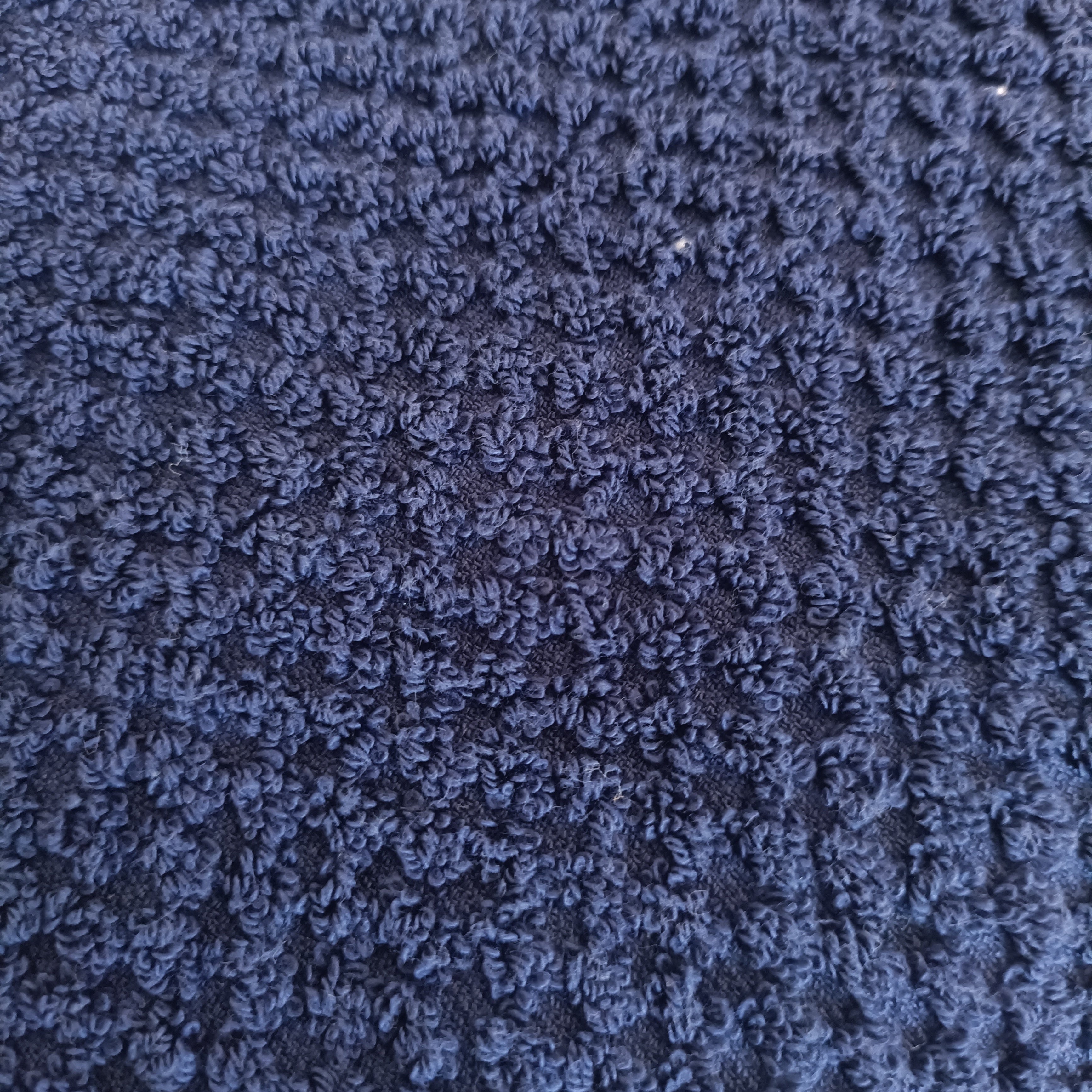 Close-up of a textured blue fabric surface