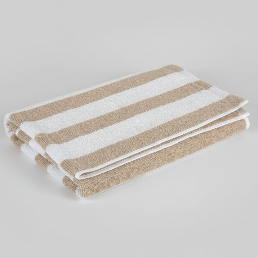 Striped towel with brown and beige pattern on a dark surface