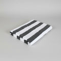 Black and white striped towel on a light-colored surface