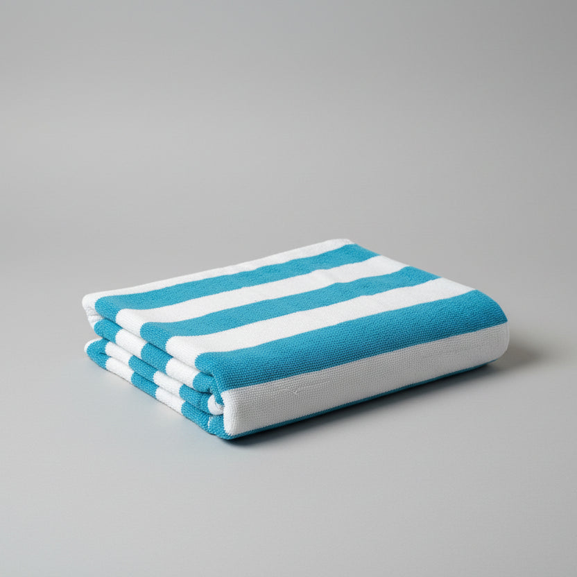 Blue and white striped towel on a gray surface