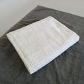 White towel on a dark surface with a blurred background