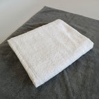 White towel on a dark surface with a blurred background