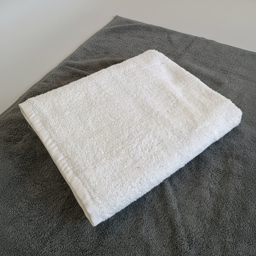 White towel on a dark surface with a blurred background