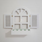 White decorative window frame with shutters on a beige background