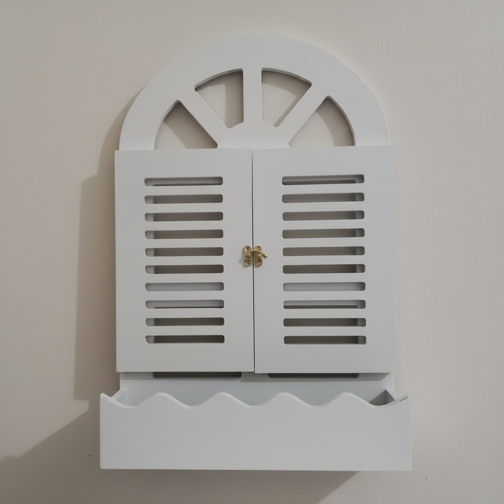 White decorative cabinet with shutter design on a plain background