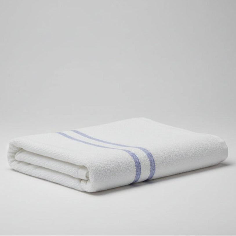 Folded White towel with blue stripes on a light gray background