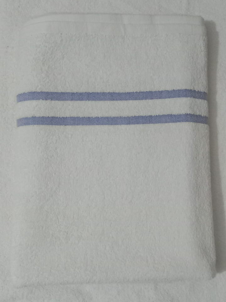 Folded gray towel with blue stripes on a light gray background