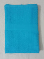 Turquoise towel folded on a light gray background