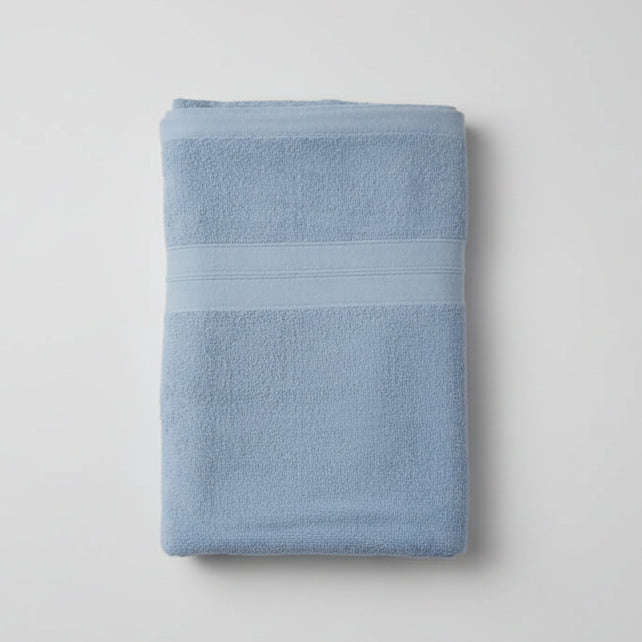 Folded blue towel on a light gray background