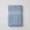 Folded blue towel on a light gray background