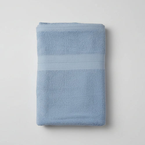 Folded blue towel on a light gray background